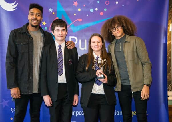 Diversity members Jordan Banjo, left, and Perri Kiely, right, with members of Sutton Community Academy's court team.