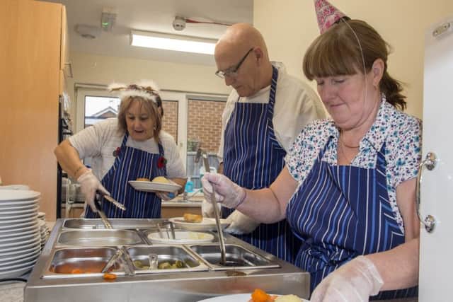 Lynds Close Luncheon club in Edwinstowe. A busy kitchen serving up lunch, from left, Sue Howells, John Taylor and Helen WardPicture: Sarah Washbourn / www.yellowbellyphotos.com