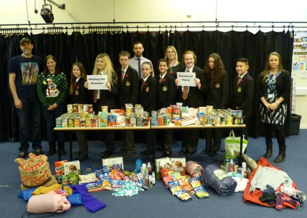 Students and staff from Caritas house with some of the items they collected for the homeless.