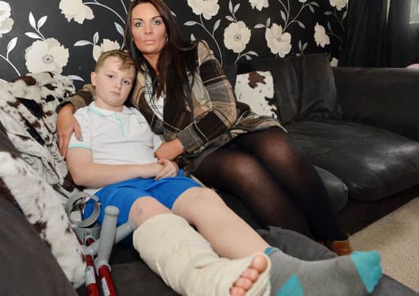 Oliver Caske suffered a broken leg at play centre. Pictured with Mum Amanda.