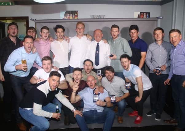 Ollerton Town's victorious squad toast promotion.