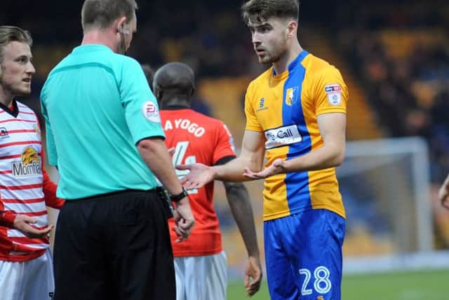 Mansfield Town v Crewe Alexander.New signing Ben Whiteman appeals to the referee Mark Brown before receiving a yellow card.