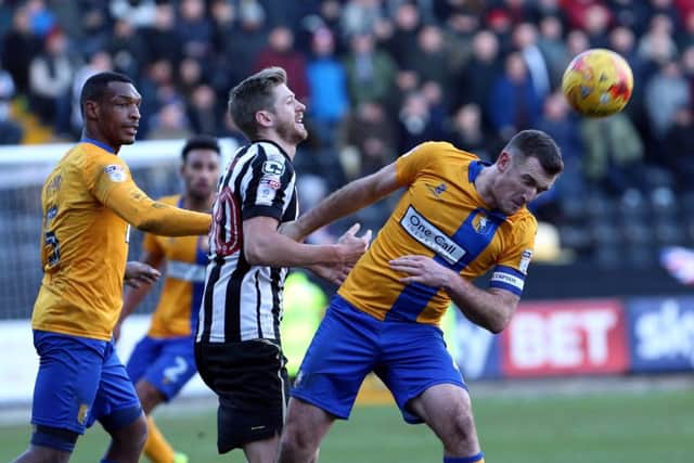 Notts County's Jon Stead and Mansfield Town's Lee Collins

 battle for the ball. Picture by Dan Westwell.