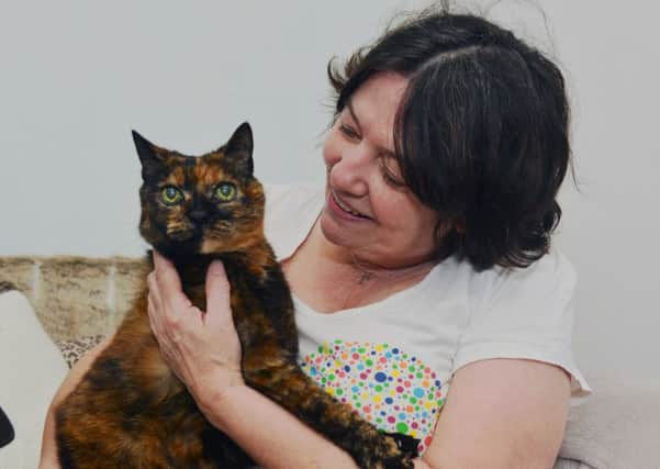 Kathleen Jackson pictured with her cat Chloe who she thinks may be the oldest in Mansfield