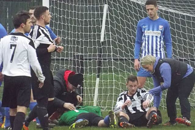 Injured Teversal goalkeeper Josh Turton is treated for concussion before having to go off. (PHOTO BY: Keith Parnill)