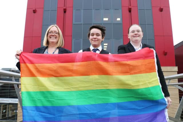 Flying the rainbow flag for West Nottinghamshire College are (from left) vice-principal Louise Knott, student representative Alex Belcher and staff representative Jane Hawksford.