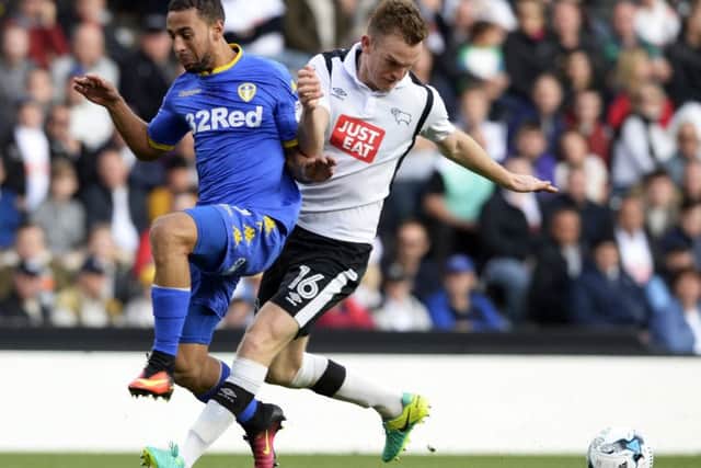 Kemar Roofe is pushed off the ball by Alex Pearce.
Derby County v Leeds United. Ipro Stadium. SkyBet Championship. 15 October 2016. Picture Bruce Rollinson