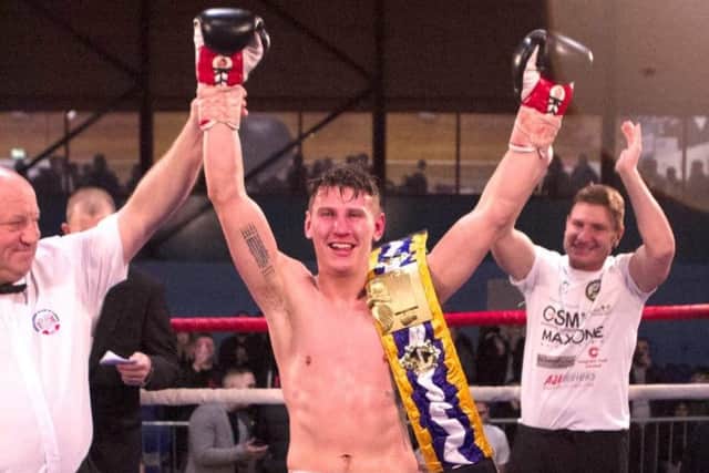 Jubilant boxer Nathan Kirk celebrates after winning the International Challenge Belt title.
