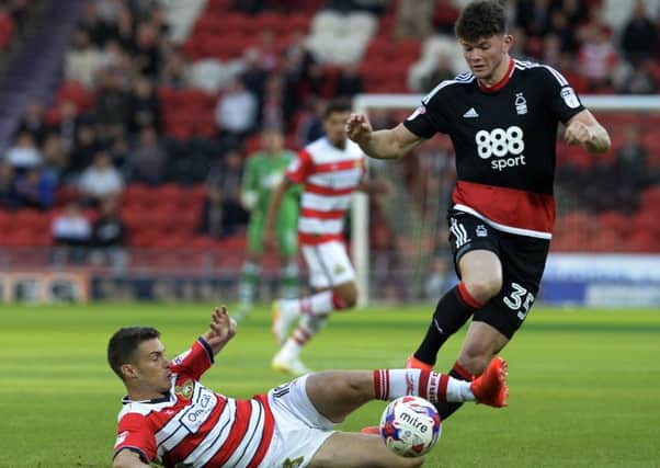 Tommy Rowe slides in on Oliver Burke.
Doncaster Rovers v Nottingham Forest. EFL Cup 1st round.  9 August 2016.  Picture Bruce Rollinson