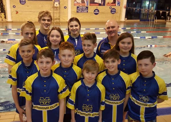 Some of the swimmers from the Mansfield club who qualified for the county championships, with head coach Barry Tindall.