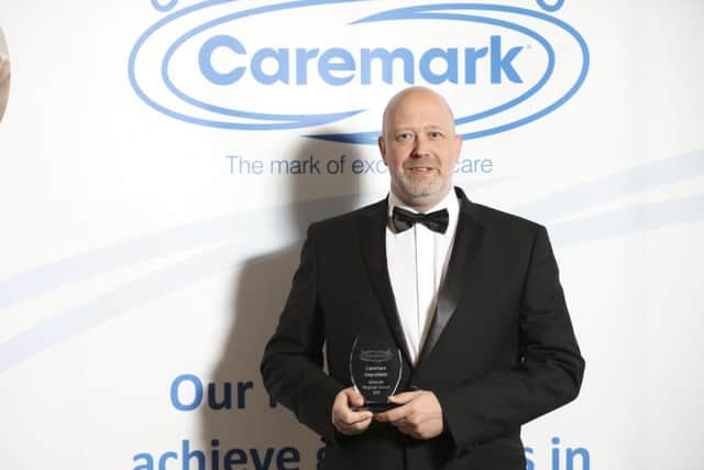 Proud Phil Mason, director of the Mansfield Caremark business, with the Midlands regional award.
