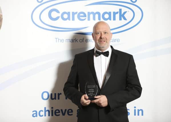 Proud Phil Mason, director of the Mansfield Caremark business, with the Midlands regional award.