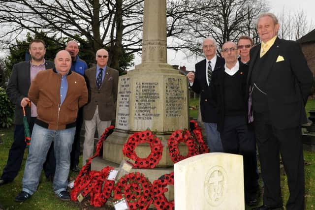 Members of the Royal British Legion by the war memorial in St Albans Church, Forest Town.
