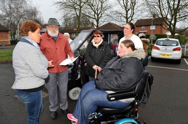 Residents on Eastfield Close, Clipstone are furious at plans to build new houses on their car park, pictured are residents and their family and friends discussing the plans