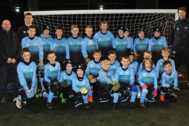 Kids from the AC1 Adam Collin Goalkeeper School show off their new kits supplied to them by Andy Perry of Power Saving Solutions.