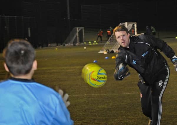 Adam Collin who runs the AC1 Adam Collin Goalkeeper School puts one of his young students through his paces at the Joseph Whitaker School all weather pitches.