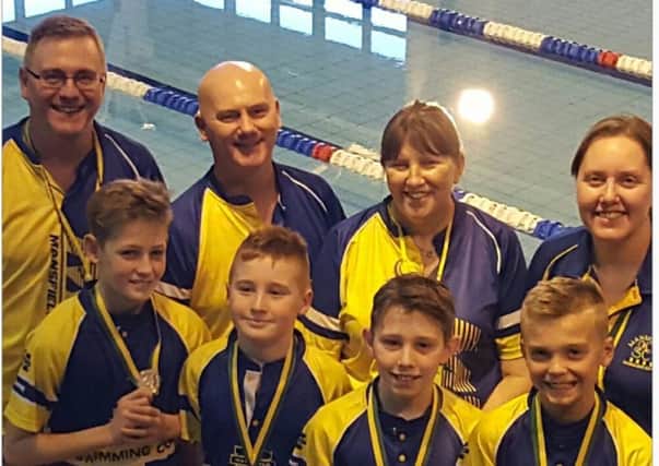 Some of the successful competitors from Mansfield Swimming Club, with their coaches.