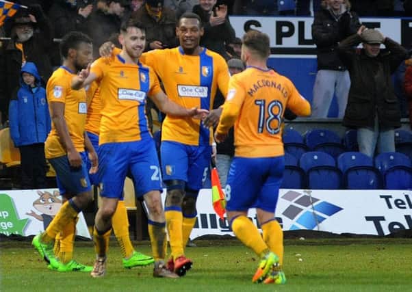 Mansfield Town's Ben Whiteman celebrates the Stags' fourth goal with provider Alex MacDonald.