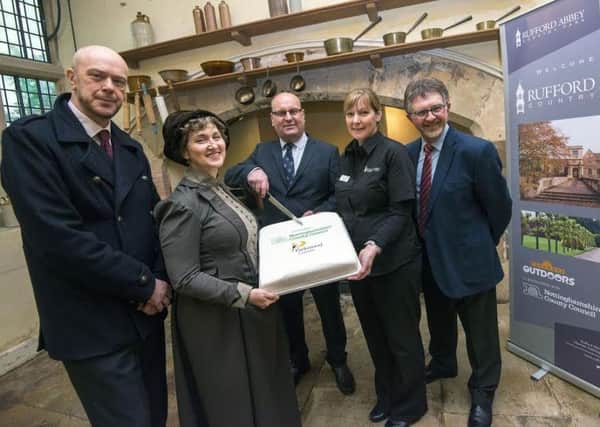 Cutting the cake to celebrate the partnership between the County Council and Parkwood are, from left: Coun John Knight, storyteller Nicky Rafferty, Parkwood Leisures Glen Hall, Rufford catering manager Isabel Garratt and council leader Coun Alan Rhodes. Picture: Tracey Whitefoot