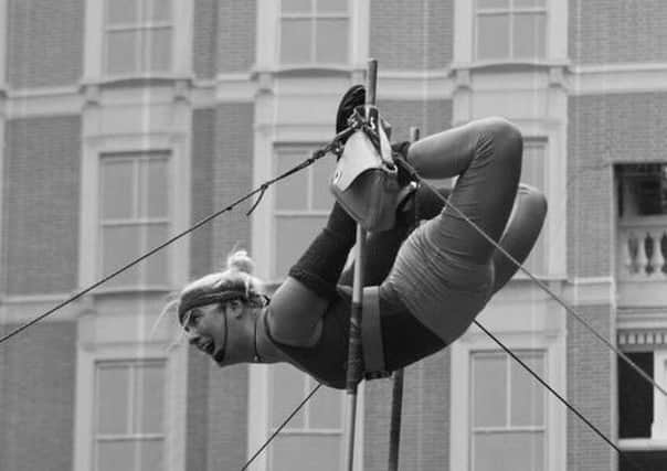 Daredevil stuntwoman Felicity Footloose hanging from the sky in her show.