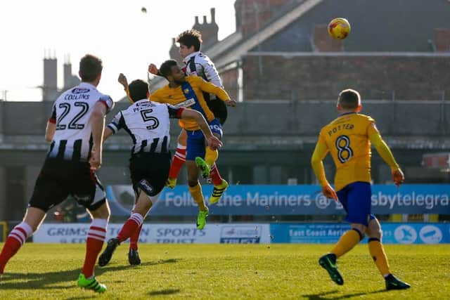 Mansfield Town's Matt Green wins the header - Photo by Chris Holloway