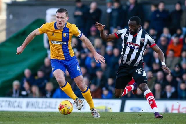 Mansfield Town's Lee Collins looks to make the pass from mid-field - Photo by Chris Holloway