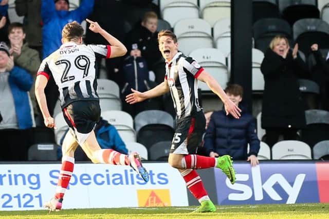 Grimsby Town's Calum Dyson celebrates his second goal with team mate Sam Jones - Photo by Chris Holloway