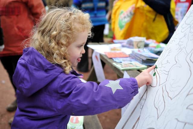 Anti-fracking demo at Sherwood Forest, Phoebe Williams, three paints leaves on a drawing of the Major Oak