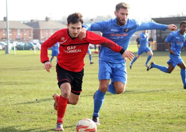 Lewis Bingham (left) holding off a Campion defender during Ollerton Town's 2-0 defeat on Saturday. (PHOTO BY: DC Photography, Retford)