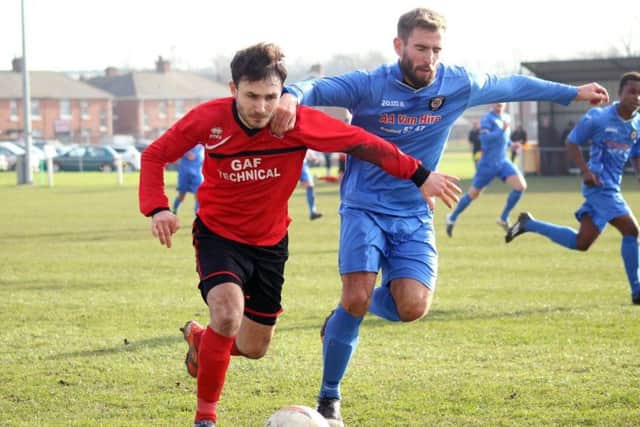 Lewis Bingham (left) holding off a Campion defender during Ollerton Town's 2-0 defeat on Saturday. (PHOTO BY: DC Photography, Retford)