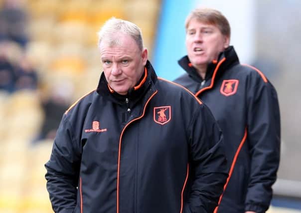 Mansfield Town Manager Steve Evans with assistant Paul Raynor behind.
Picture by Dan Westwell.