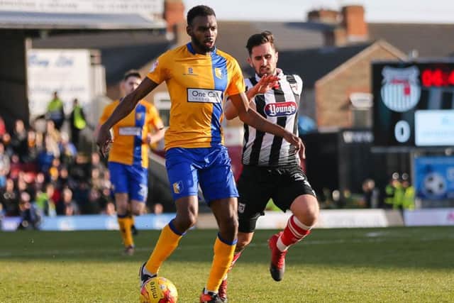 Mansfield Town's Hayden White advances past ex Stag Chris clements  - Photo by Chris Holloway