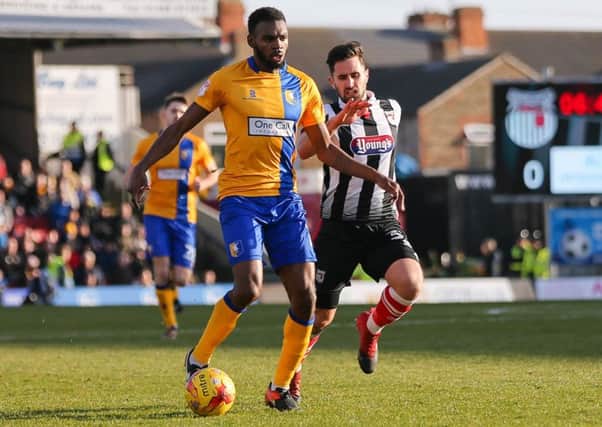 Mansfield Town's Hayden White advances past ex Stag Chris clements  - Photo by Chris Holloway