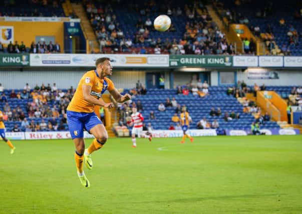 Mansfield Town's Kyle Howkins heads forward  - Pic Chris Holloway