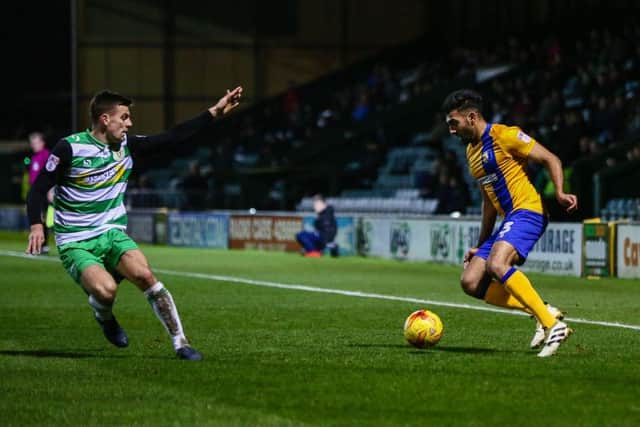 Mansfield Town's Mal Benning looks to make the cross - Photo by Chris Holloway