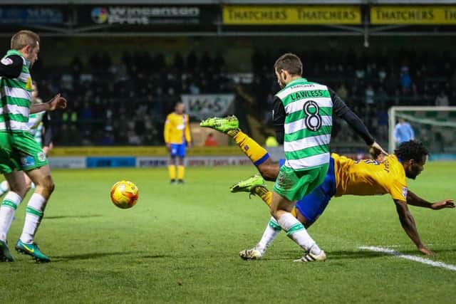 Mansfield Town's Shaquile Coulthirst goes down - Photo by Chris Holloway