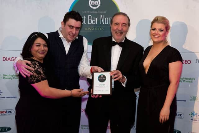 Manager Damien Calko and colleagues Elena Parker (left) and Kirsty Layton receive andwhynots award from police and crime commissioner Paddy Tipping (second right).