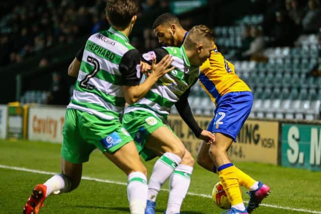Mansfield Town's CJ Hamilton takes on the Yeovil defence - Photo by Chris Holloway