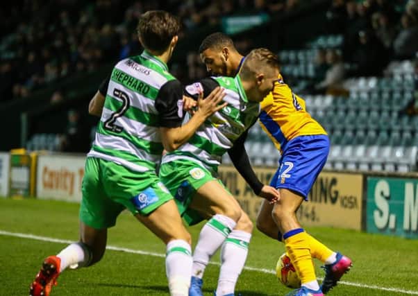 Mansfield Town's CJ Hamilton takes on the Yeovil defence - Photo by Chris Holloway