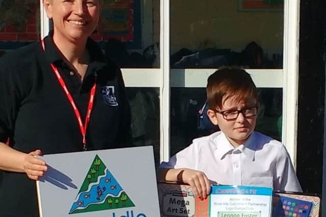 Schoolboy Lennon Foster, with his winning design, receives his prize from Claire Sambridge, of Nottinghamshire Wildllife Trust.