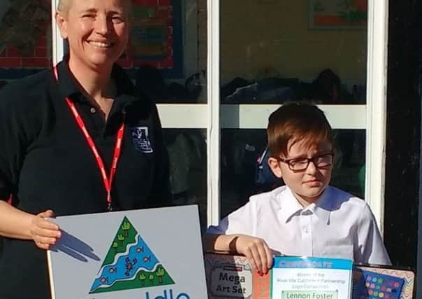 Schoolboy Lennon Foster, with his winning design, receives his prize from Claire Sambridge, of Nottinghamshire Wildllife Trust.