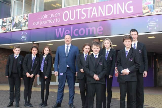 Pupils and principal Tim Croft celebrating Sutton Community Academys latest achievement.