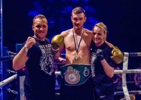 Newly-crowned champion Callam Atkinson, flanked by coach Paul Hillman and 24-year-old girlfriend Hannah Gibson, who also fights, after winning his Golden Gloves Boxing League title.