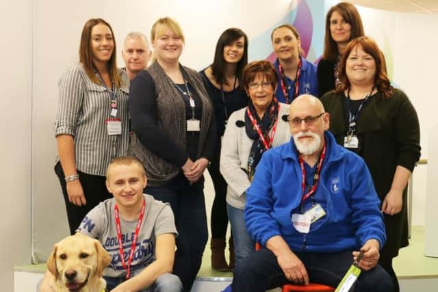 Puppy Nathan with his ex-student namesake, Nathan Edge and his own guide dog, Nichola Bonsall, of the Guide Dogs charity, and the visual impairment team at West Notts College