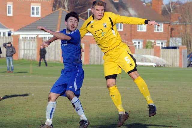Matchwinner Lewis Bingham (left), who scored the only goal of the game to ensure Ollerton Towns safety.