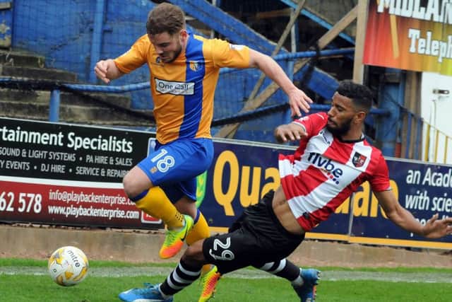 Mansfield Town v Exeter.Alex MacDonald is taken out in the first half.