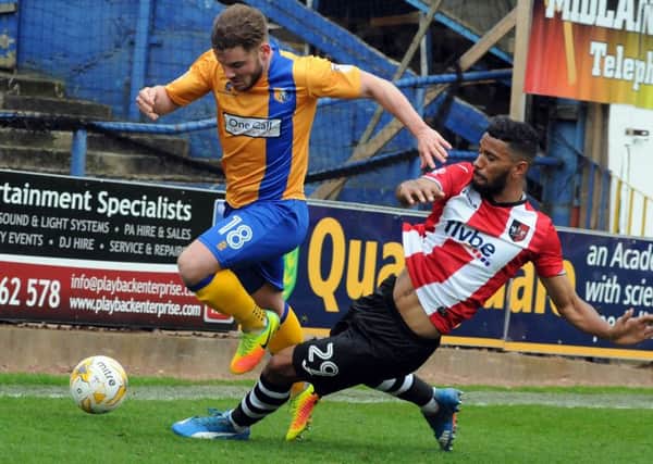 Mansfield Town v Exeter.
Alex MacDonald is taken out in the first half.