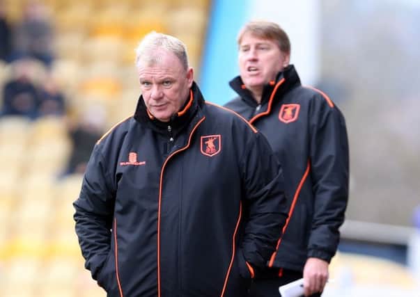 Mansfield Town Manager Steve Evans with assistant Paul Raynor behind.
Picture by Dan Westwell.