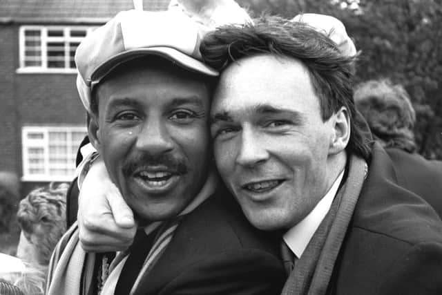 Wembley penalty shoot-out matchwinner Tony Kenworthy, right, celebrates Mansfield Town's Freight Rover Trophy triumph with Keith Cassells on the open-top bus parade the following day.