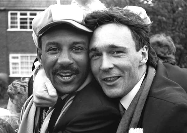 Wembley penalty shoot-out matchwinner Tony Kenworthy, right, celebrates Mansfield Town's Freight Rover Trophy triumph with Keith Cassells on the open-top bus parade the following day.
